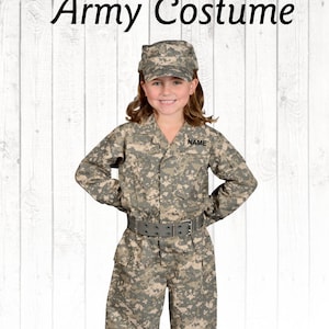 May include: A child wearing a camouflage army costume with a name tag that says "NAME". The costume includes a hat, jacket, and pants.