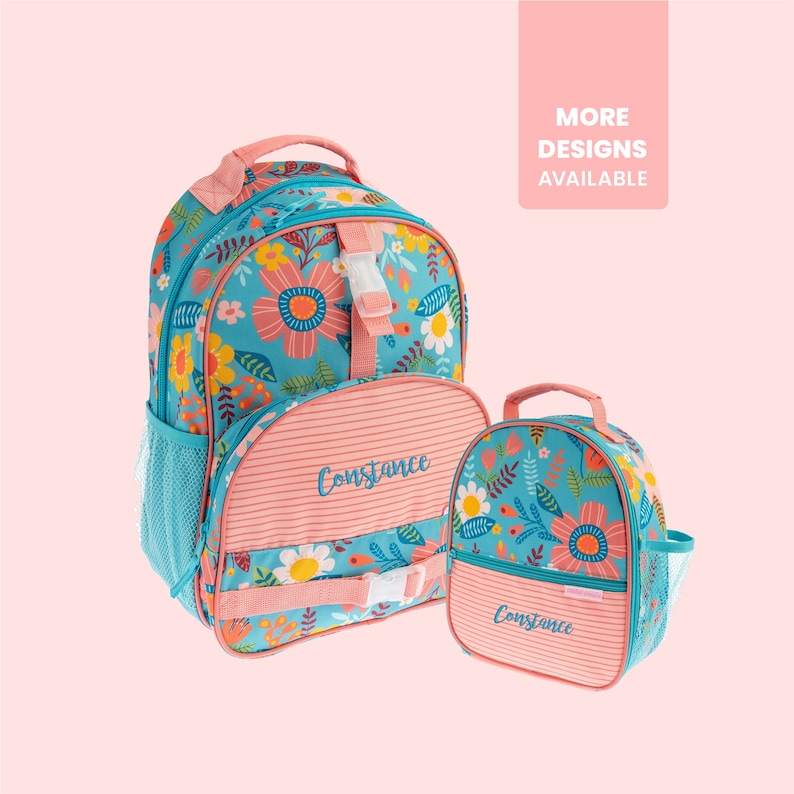 May include: A pink and blue floral backpack and lunch bag set with the name "Constance" embroidered on both. The backpack has a mesh side pocket and a front pocket with a buckle closure. The lunch bag has a top handle and a side mesh pocket.