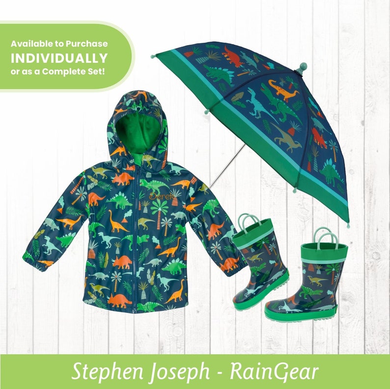 May include: A blue raincoat with a dinosaur print, a green umbrella with a dinosaur print, and a pair of green rain boots with a dinosaur print. The text "Available to Purchase INDIVIDUALLY or as a Complete Set!" is in a green circle at the top of the image. The text "Stephen Joseph - RainGear" is at the bottom of the image.