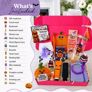 May include: A bright pink gift box containing a Halloween-themed collection including a crochet pumpkin, fuzzy white socks, a glass cup with a pumpkin print, a purple notebook, a beaded bracelet, hand cream, a reading light, and a pen.
