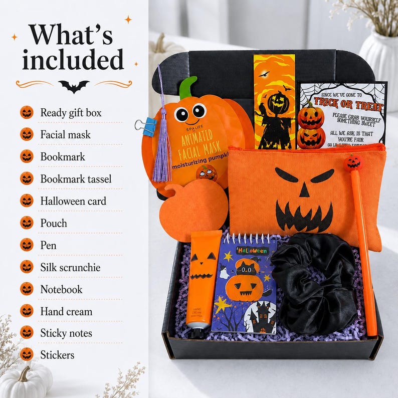 May include: A black gift box containing Halloween-themed items: an orange pumpkin-shaped facial mask, a bookmark with a purple tassel, a card, an orange pouch with a jack-o'-lantern face, a pen, a black silk scrunchie, a notebook, and hand cream.
