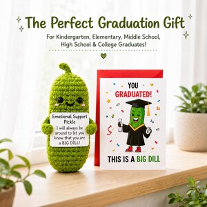 May include: A green crocheted pickle toy holding a sign saying "Emotional Support Pickle." Next to it is a graduation card with a cartoon pickle in a cap and gown. The card reads "You Graduated!" and "This is a Big Dill."