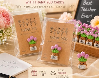 May include: Two kraft paper thank you cards with floral line art and a small clay tulip pot figurine attached to each. The figurines feature pink tulips in a brown pot with a sign reading Thank you for helping me grow and learn.