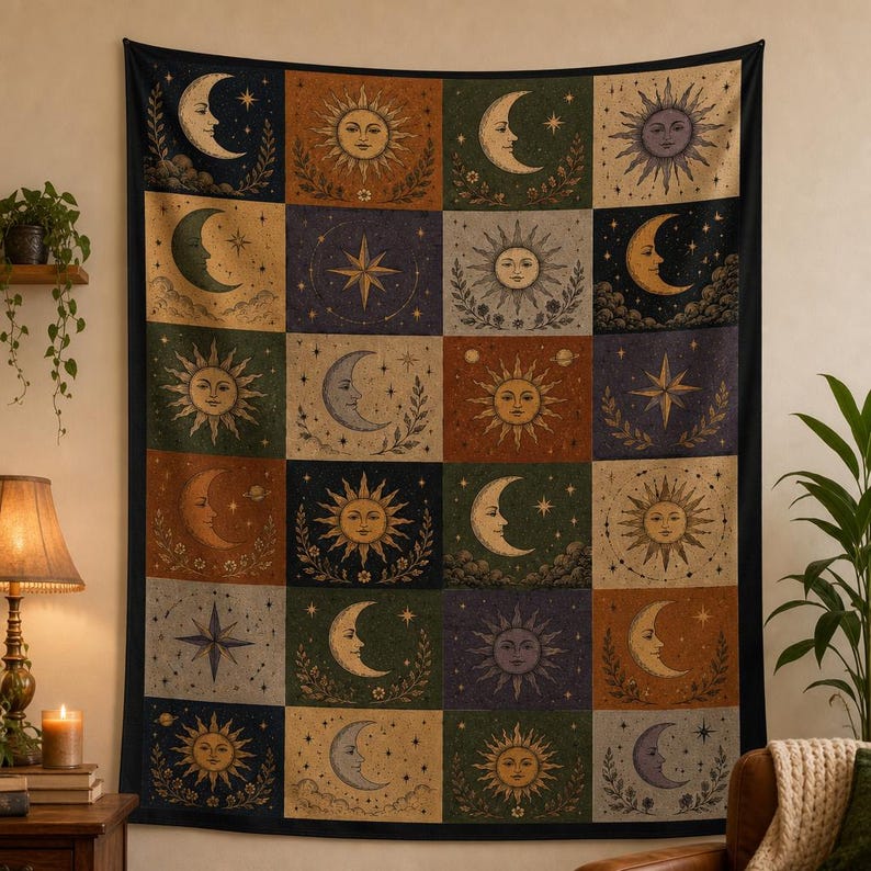 May include: A tapestry featuring a celestial design with suns, moons, and stars in a grid pattern. The artwork uses a palette of earthy tones, including brown, green, and gold, with a black border. The tapestry is likely used as wall decor.