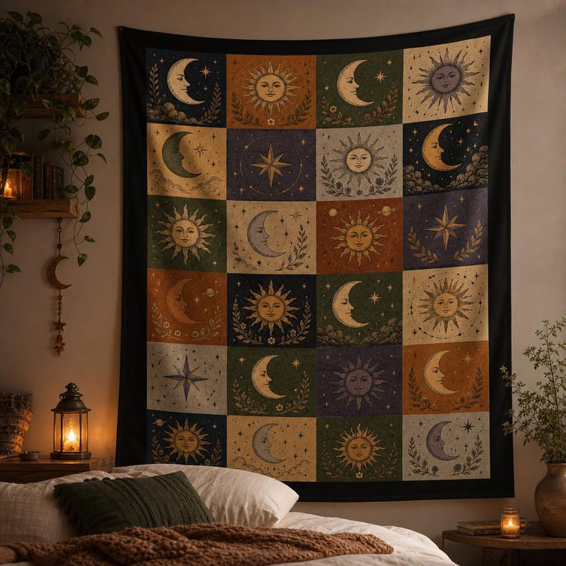 May include: A large tapestry featuring a celestial design with suns, moons, and stars in a grid pattern. The artwork uses a vintage color palette of greens, oranges, blues, and creams. The tapestry is rectangular and hangs on a wall, adding a bohemian touch to the room.
