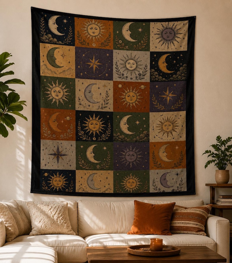 May include: A large tapestry with a black border, featuring a grid of celestial designs. Each square showcases a sun, moon, or star in various colors like gold, orange, and blue, set against a backdrop of green, purple, and beige.