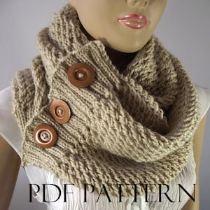 May include: A beige knitted cowl neck scarf with three brown wooden buttons. The scarf is worn by a mannequin. The text "PDF PATTERN" is printed at the bottom of the image.