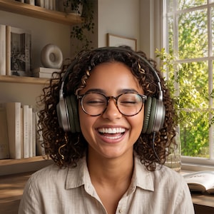 May include: Over-ear headphones with olive green ear cushions and silver metallic accents. The headphones feature a thin, adjustable headband and a wired connection extending from the right side, designed for comfortable audio listening.