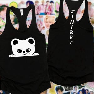 May include: Black vest top featuring a white cartoon bear design on the front. The bear has large eyes and is peeking over a line. The back of the vest top has the word "JINRET" printed vertically in white.