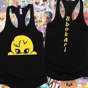May include: Black racerback vest with a yellow cartoon character design on the front. The character has a round head, two eyes, and a small mouth. The word "Bbokari" is printed vertically in yellow on the back of the vest.