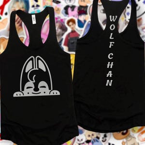 May include: Black racerback vest with a white cartoon dog graphic on the front. The back of the vest has the name "WOLFCHAN" printed vertically in white. The vest is made of a soft, lightweight material.
