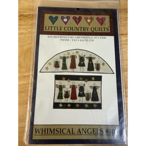 May include: A sewing pattern packet titled Little Country Quilts Whimsical Angels #40. The cover features illustrations of two angel-themed quilt designs with figures in plaid and solid dresses, accented by stars, against a cream background.