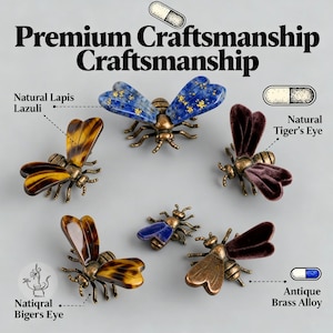 May include: A collection of six bee-shaped decorative objects with antique brass alloy bodies. The wings are crafted from natural lapis lazuli, tiger's eye, and velvet-textured materials. Text includes Premium Craftsmanship, Natural Lapis Lazuli, Natural Tiger's Eye, and Antique Brass Alloy.