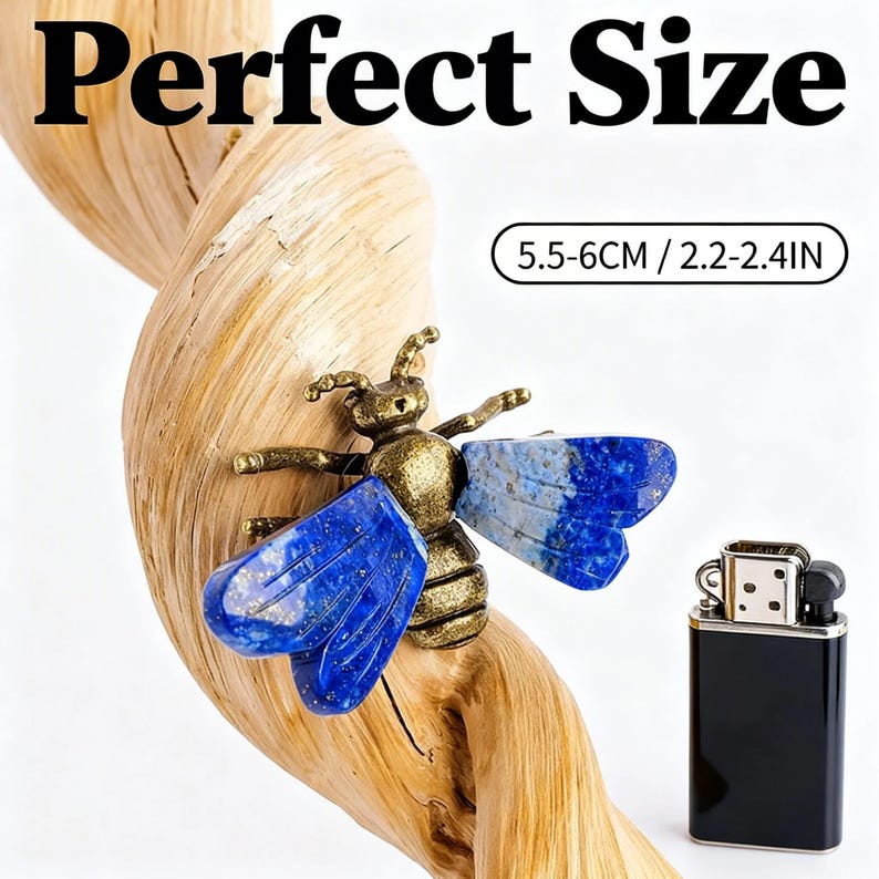 May include: A bee-shaped ornament with a metallic bronze-toned body and deep blue lapis lazuli wings. The item is displayed on a twisted piece of light-colored wood next to a black lighter. Text on the image reads Perfect Size 5.5-6CM / 2.2-2.4IN.