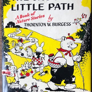 May include: Vintage children's book cover titled "The Crooked Little Path" by Thornton W. Burgess, illustrated by Harrison Cady. The cover features a yellow background with illustrations of animals and a bear carrying a basket.
