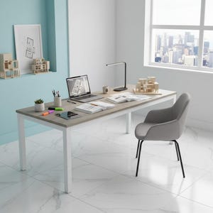 May include: A modern office desk with a light wood-grain top and white legs. A laptop, books, and a desk lamp are on the desk. A gray chair with black legs sits nearby. The room has a large window with a city view.