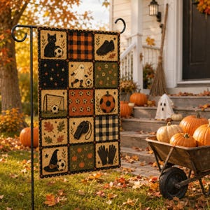 May include: A rectangular garden flag featuring a grid of fifteen squares with Halloween and soccer themes, including a black cat, a ghost, a soccer ball, a goal, a whistle, a witch hat, a pumpkin, and gloves, all framed by a black scalloped border.