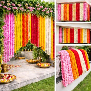 May include: A vibrant display of colorful flower garlands, including pink, yellow, orange, red, and white, arranged in vertical rows. The garlands are used as decorative elements, possibly for a celebration or event. The scene is set outdoors with greenery and floral arrangements.