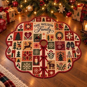May include: A round, scalloped-edge Christmas tree skirt featuring a patchwork design of festive icons including reindeer, pine trees, snowflakes, and a mug. The center text reads THE WILSON Family. It includes three red ribbon ties for closure.