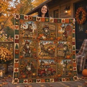 May include: A rectangular quilt featuring a grid of nine panels depicting cartoon donkeys in autumn settings with pumpkins, sunflowers, and red barns. The border is decorated with a pattern of leaves, stars, and plaid squares. The text reads Happy Autumn.