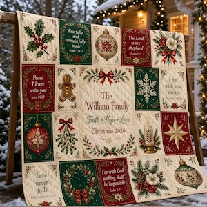 May include: A quilted Christmas blanket featuring a central panel with the text The William Family, Faith, Hope, Love, Christmas 2026, surrounded by rectangular blocks displaying holly, gingerbread men, ornaments, snowflakes, and Bible verses.