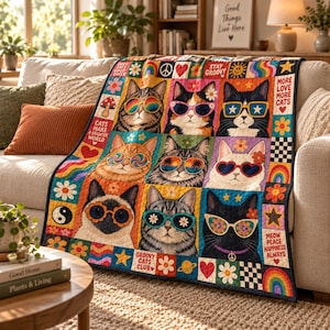 May include: A colorful quilt featuring a grid of nine cat portraits, each wearing distinct patterned sunglasses. The design includes retro motifs like flowers, rainbows, peace signs, and hearts, with text reading "Cats Make a Brighter World" and "Meow Peace Happiness Always."