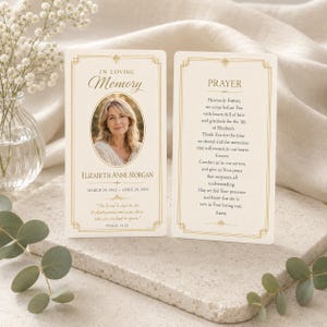 May include: Two rectangular memorial prayer cards with gold borders. The left card features the text IN LOVING MEMORY, a portrait of a woman, the name ELIZABETH ANNE MORGAN, dates, and a Bible verse. The right card displays the title PRAYER and text.