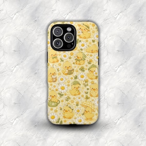May include: Yellow phone case with a repeating pattern of cartoon ducklings, daisies, and clover. The ducklings are wearing hats, holding books, and using umbrellas. The case has a black camera module.