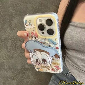 May include: Clear phone case with a cartoon design of Donald Duck and Daisy Duck. The case has a pop-up grip with a Donald Duck design. The case is yellow and clear with a yellow border. The text "LZ Cover Design" is visible.
