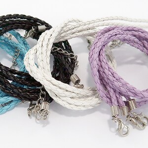 May include: Four braided leather cords in blue, white, black, and purple with silver clasps. The cords are twisted together and are ready to be used for a variety of projects.