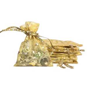 May include: A stack of gold organza gift bags with a gold ribbon and star and crescent moon design. The bags are perfect for small gifts or favors.