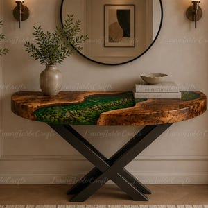 May include: A half-moon console table with a live edge design. The table features a river of green resin and a dark wood finish. It has black metal legs and is decorated with a vase and books.