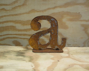 Lowercase metal letter "a" on stand