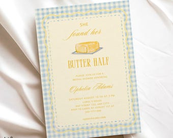 May include: A rectangular invitation card with a light blue and white gingham border. The centre features a yellow illustration of a stick of butter on a plate with the text: SHE found her BUTTER HALF. PLEASE JOIN US FOR A BRIDAL SHOWER HONORING Ophelia Adams.