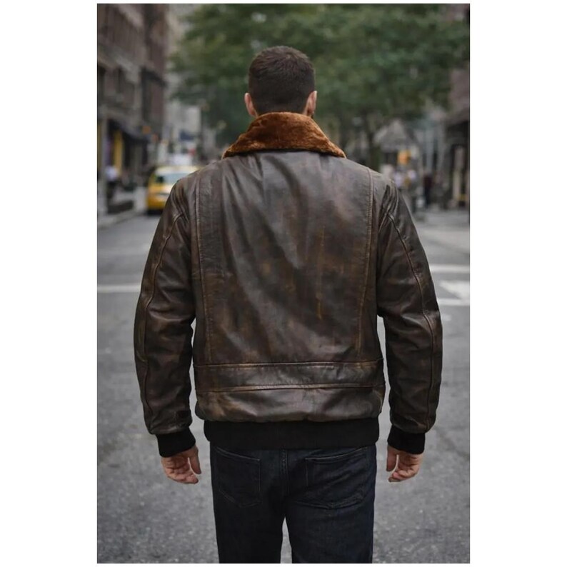 Men wearing distressed brown leather bomber jacket with fur collar and vintage aviator style.
