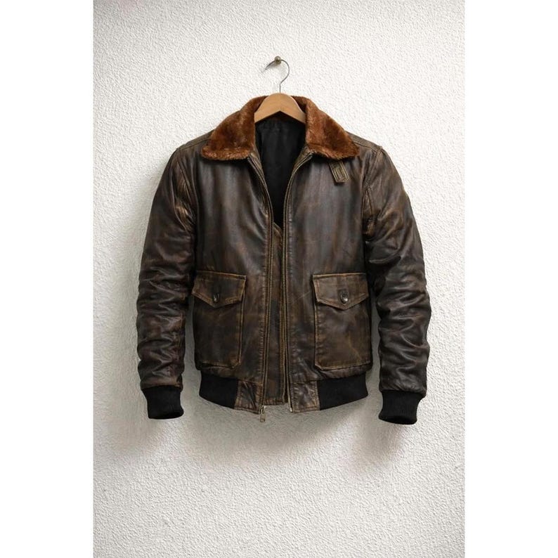Men wearing distressed brown leather bomber jacket with fur collar and vintage aviator style.