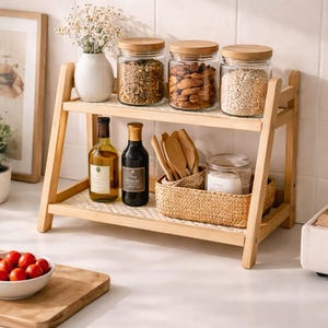 May include: A set of three ceramic vases in varying heights. The vases have a matte finish in shades of cream, beige, and brown. The tallest vase is approximately 25 cm high.