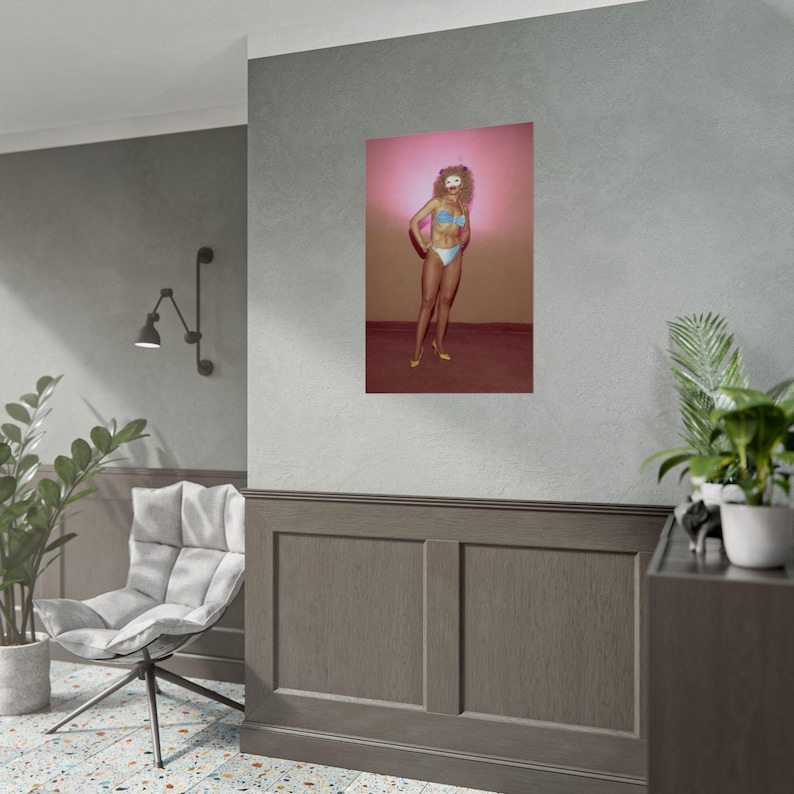 a poster of a woman with a colorful, stylized design on a gray wall.