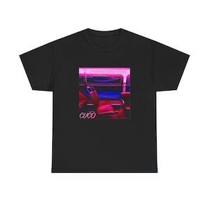 May include: Black t-shirt featuring a graphic with the text "wannabewithu" and "CUCO" in a pink and white font. The graphic is a stylized image of a bus interior with red seats.