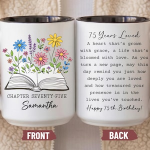 May include: White ceramic mug with a black rim and handle, featuring a floral design and the text "Chapter Seventy-Five Samantha" on the front. The back of the mug has a poem and the text "75 Years Loved" and "Happy 75th Birthday!"