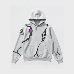 May include: A light gray hooded sweatshirt featuring a black graphic design that resembles cracked patterns. The design includes a circular green and gray emblem on the right sleeve and a small pink eye-like detail on the front chest area.