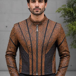 May include: A brown snakeskin-patterned jacket featuring a mandarin collar, a central silver-toned zipper, and black vertical piping accents. The garment includes black ribbed side panels and long sleeves with matching snakeskin texture and piping.