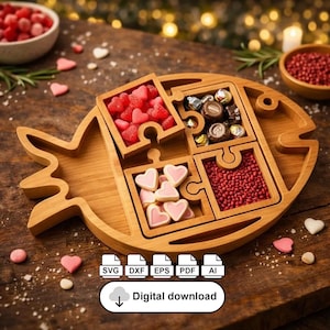 May include: A wooden fish-shaped serving tray with four puzzle-piece compartments filled with candies and treats. The tray is made of light-colored wood and is surrounded by small heart-shaped candies. The image also includes a bowl of red candies.