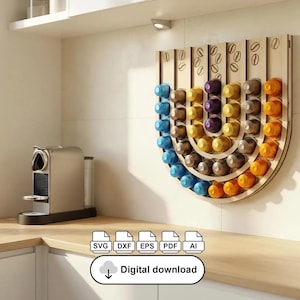 May include: A wooden coffee pod holder in a semi-circular shape, filled with colourful coffee pods. The holder is mounted on a white wall, with a coffee machine on a wooden surface. The image includes the text "Digital download".