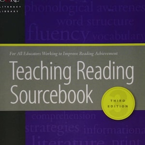 May include: The Teaching Reading Sourcebook Third Edition is a textbook with a gray cover featuring white text. The title is centered in large font, with the subtitle For All Educators Working to Improve Reading Achievement above it.