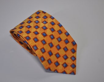 May include: A yellow tie with a blue and orange geometric pattern.