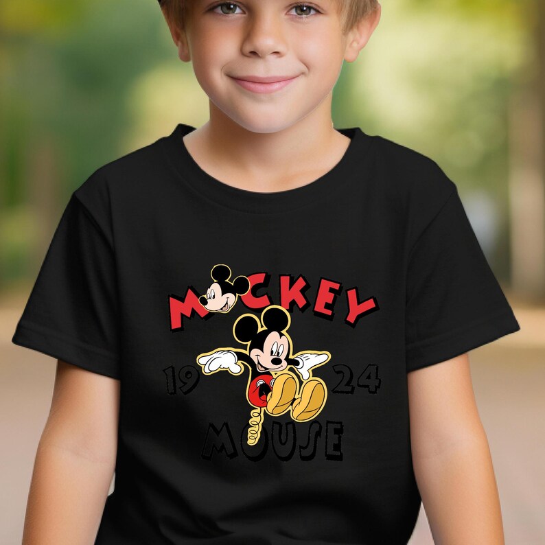 May include: Black t-shirt with a Mickey Mouse graphic. The design features the word "Mickey" in red, the year "1924", and the word "Mouse" in black. Mickey Mouse is shown in his classic pose, with yellow shoes and red shorts.