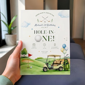 May include: A rectangular birthday invitation card featuring a golf theme with watercolor illustrations of a golf cart, a green, a flag, and balloons. The text reads "Michael's 1st Birthday will be a HOLE-IN-ONE!" with event details including date, time, and location.