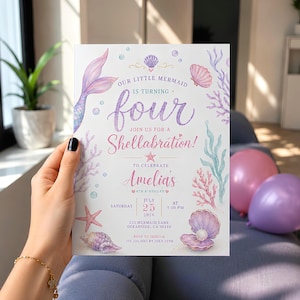 May include: A white rectangular birthday invitation card featuring watercolor illustrations of a mermaid tail, seashells, coral, and bubbles. The text reads: Our little mermaid is turning four, join us for a Shellabration, Amelia's 4th birthday, July 25, 2026.