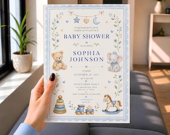 May include: A rectangular baby shower invitation card featuring a light blue scalloped border, watercolor illustrations of a teddy bear, elephant, rocking horse, and train, with text reading BABY SHOWER, SOPHIA JOHNSON, OCTOBER 15, 2027, and location details.